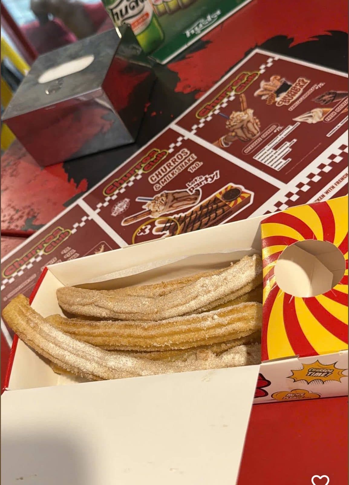 Churros and a cold beer on the table