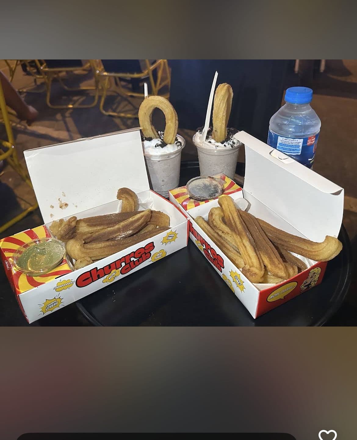 Oreo milkshake churro cups next to a bottle of water