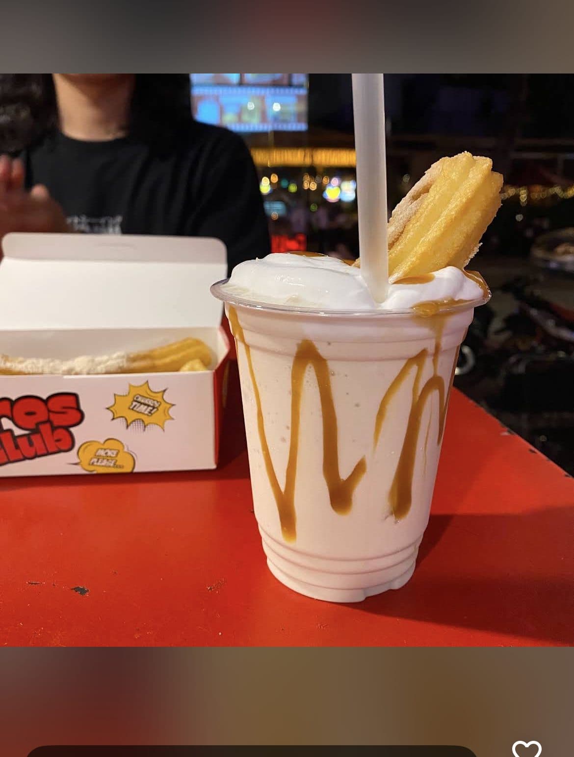 Churro milkshake at night with the shop lights in the background